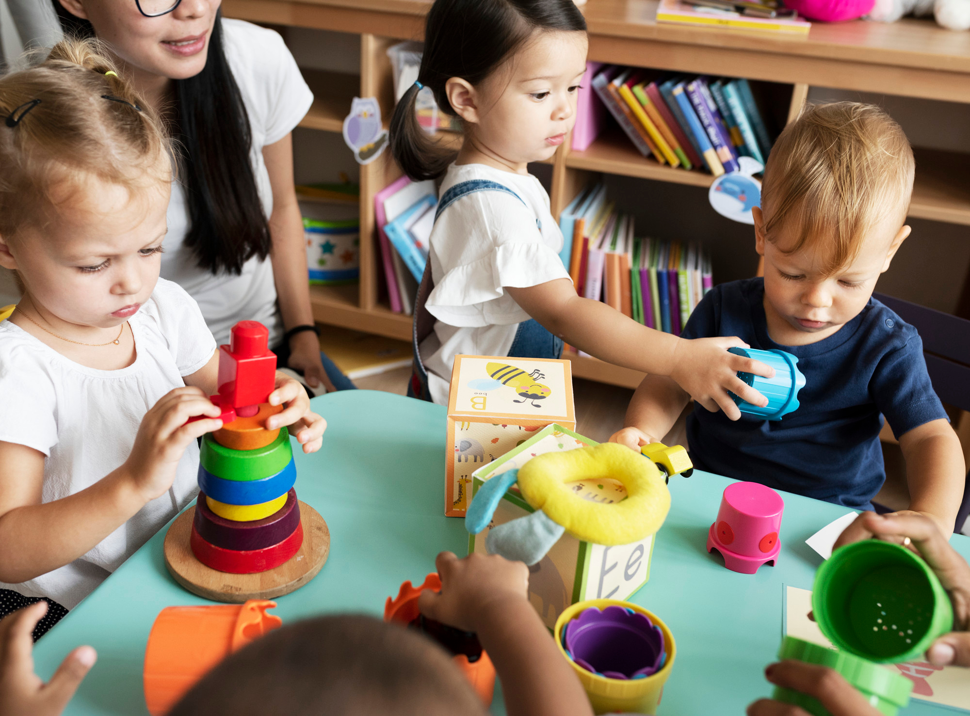 nursery-children-playing-with-teacher-classroom
